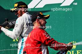 Sebastian Vettel (GER) Ferrari celebrates his second position on the podium with race winner Lewis Hamilton (GBR) Mercedes AMG F1. 29.07.2018. Formula 1 World Championship, Rd 12, Hungarian Grand Prix, Budapest, Hungary, Race Day.