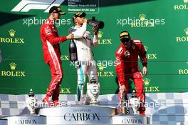 (L to R): Sebastian Vettel (GER) Ferrari celebrates with the champagne his second position on the podium with race winner Lewis Hamilton (GBR) Mercedes AMG F1 and third placed Kimi Raikkonen (FIN) Ferrari. 29.07.2018. Formula 1 World Championship, Rd 12, Hungarian Grand Prix, Budapest, Hungary, Race Day.