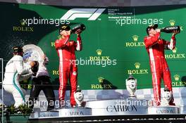 (L to R): Race winner Lewis Hamilton (GBR) Mercedes AMG F1 celebrates with the champagne on the podium with second placed Sebastian Vettel (GER) Ferrari and third placed Kimi Raikkonen (FIN) Ferrari. 29.07.2018. Formula 1 World Championship, Rd 12, Hungarian Grand Prix, Budapest, Hungary, Race Day.