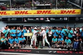 (L to R): Race winner Lewis Hamilton (GBR) Mercedes AMG F1 celebrates with third placed team mate Valtteri Bottas (FIN) Mercedes AMG F1 and the team. 02.09.2018. Formula 1 World Championship, Rd 14, Italian Grand Prix, Monza, Italy, Race Day.