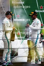 Race winner Lewis Hamilton (GBR) Mercedes AMG F1 (Right) celebrates with third placed team mate Valtteri Bottas (FIN) Mercedes AMG F1 on the podium. 02.09.2018. Formula 1 World Championship, Rd 14, Italian Grand Prix, Monza, Italy, Race Day.