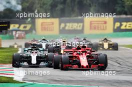 Kimi Raikkonen (FIN) Ferrari SF71H leads Lewis Hamilton (GBR) Mercedes AMG F1 W09 and Sebastian Vettel (GER) Ferrari SF71H at the start of the race. 02.09.2018. Formula 1 World Championship, Rd 14, Italian Grand Prix, Monza, Italy, Race Day.