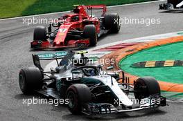 Valtteri Bottas (FIN) Mercedes AMG F1 W09 leads Kimi Raikkonen (FIN) Ferrari SF71H. 02.09.2018. Formula 1 World Championship, Rd 14, Italian Grand Prix, Monza, Italy, Race Day.