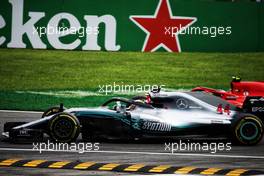 Kimi Raikkonen (FIN) Ferrari SF71H and Lewis Hamilton (GBR) Mercedes AMG F1 W09 battle for the lead of the race. 02.09.2018. Formula 1 World Championship, Rd 14, Italian Grand Prix, Monza, Italy, Race Day.