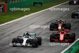 Lewis Hamilton (GBR) Mercedes AMG F1 W09 and Kimi Raikkonen (FIN) Ferrari SF71H battle for the lead of the race. 02.09.2018. Formula 1 World Championship, Rd 14, Italian Grand Prix, Monza, Italy, Race Day.