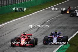Sebastian Vettel (GER) Ferrari SF71H and Pierre Gasly (FRA) Scuderia Toro Rosso STR13 battle for position. 02.09.2018. Formula 1 World Championship, Rd 14, Italian Grand Prix, Monza, Italy, Race Day.