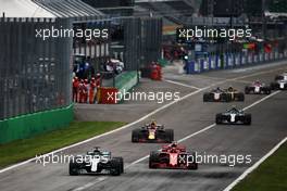 Lewis Hamilton (GBR) Mercedes AMG F1 W09 and Kimi Raikkonen (FIN) Ferrari SF71H battle for the lead of the race. 02.09.2018. Formula 1 World Championship, Rd 14, Italian Grand Prix, Monza, Italy, Race Day.