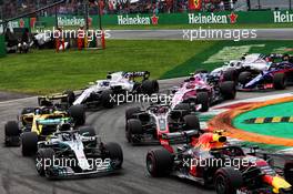 Valtteri Bottas (FIN) Mercedes AMG F1 W09, Max Verstappen (NLD) Red Bull Racing RB14 and Romain Grosjean (FRA) Haas F1 Team VF-18, at the start of the race. 02.09.2018. Formula 1 World Championship, Rd 14, Italian Grand Prix, Monza, Italy, Race Day.