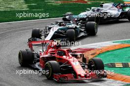 Kimi Raikkonen (FIN) Ferrari SF71H leads Lewis Hamilton (GBR) Mercedes AMG F1 W09. 02.09.2018. Formula 1 World Championship, Rd 14, Italian Grand Prix, Monza, Italy, Race Day.