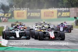 Romain Grosjean (FRA) Haas F1 Team VF-18 and Valtteri Bottas (FIN) Mercedes AMG F1 W09 at the start of the race. 02.09.2018. Formula 1 World Championship, Rd 14, Italian Grand Prix, Monza, Italy, Race Day.