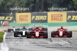 Kimi Raikkonen (FIN) Ferrari SF71H leads Lewis Hamilton (GBR) Mercedes AMG F1 W09 and Sebastian Vettel (GER) Ferrari SF71H at the start of the race. 02.09.2018. Formula 1 World Championship, Rd 14, Italian Grand Prix, Monza, Italy, Race Day.