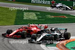 Lewis Hamilton (GBR) Mercedes AMG F1 W09 passes Kimi Raikkonen (FIN) Ferrari SF71H to take the lead of the race. 02.09.2018. Formula 1 World Championship, Rd 14, Italian Grand Prix, Monza, Italy, Race Day.