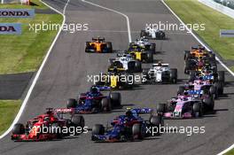 Sebastian Vettel (GER) Ferrari SF71H and Pierre Gasly (FRA) Scuderia Toro Rosso STR13 at the start of the race. 07.10.2018. Formula 1 World Championship, Rd 17, Japanese Grand Prix, Suzuka, Japan, Race Day.