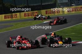 Kimi Raikkonen (FIN) Ferrari SF71H and Max Verstappen (NLD) Red Bull Racing RB14 at the start of the race. 07.10.2018. Formula 1 World Championship, Rd 17, Japanese Grand Prix, Suzuka, Japan, Race Day.