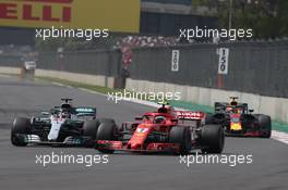 Kimi Raikkonen (FIN) Ferrari SF71H and Lewis Hamilton (GBR) Mercedes AMG F1 W09. 28.10.2018. Formula 1 World Championship, Rd 19, Mexican Grand Prix, Mexico City, Mexico, Race Day.
