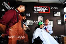 Sergio Perez (MEX) Racing Point Force India F1 Team, with Johnny Herbert (GBR) Sky Sports F1 Presenter, visits the paddock barbers. 25.10.2018. Formula 1 World Championship, Rd 19, Mexican Grand Prix, Mexico City, Mexico, Preparation Day.