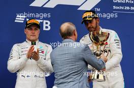 (L to R): second placed Valtteri Bottas (FIN) Mercedes AMG F1 on the podium with race winner and team mate Lewis Hamilton (GBR) Mercedes AMG F1, receiving trophy from Vladimir Putin (RUS) Russian Federation President. 30.09.2018. Formula 1 World Championship, Rd 16, Russian Grand Prix, Sochi Autodrom, Sochi, Russia, Race Day.