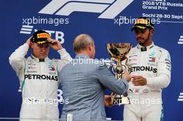 (L to R): second placed Valtteri Bottas (FIN) Mercedes AMG F1 on the podium with race winner and team mate Lewis Hamilton (GBR) Mercedes AMG F1, receiving trophy from Vladimir Putin (RUS) Russian Federation President. 30.09.2018. Formula 1 World Championship, Rd 16, Russian Grand Prix, Sochi Autodrom, Sochi, Russia, Race Day.