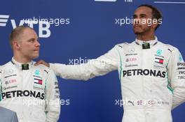 (L to R): second placed Valtteri Bottas (FIN) Mercedes AMG F1 with race winner and team mate Lewis Hamilton (GBR) Mercedes AMG F1 on the podium. 30.09.2018. Formula 1 World Championship, Rd 16, Russian Grand Prix, Sochi Autodrom, Sochi, Russia, Race Day.
