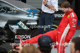 Sebastian Vettel (GER) Ferrari SF71H pushes the Mercedes in Parc Ferme. 30.09.2018. Formula 1 World Championship, Rd 16, Russian Grand Prix, Sochi Autodrom, Sochi, Russia, Race Day.