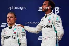 (L to R): Second placed Valtteri Bottas (FIN) Mercedes AMG F1 with race winner and team mate Lewis Hamilton (GBR) Mercedes AMG F1 on the podium. 30.09.2018. Formula 1 World Championship, Rd 16, Russian Grand Prix, Sochi Autodrom, Sochi, Russia, Race Day.