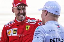 (L to R): Sebastian Vettel (GER) Ferrari with pole sitter Valtteri Bottas (FIN) Mercedes AMG F1 in qualifying parc ferme. 29.09.2018. Formula 1 World Championship, Rd 16, Russian Grand Prix, Sochi Autodrom, Sochi, Russia, Qualifying Day.