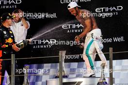 Race winner Lewis Hamilton (GBR) Mercedes AMG F1 celebrates on the podium with Max Verstappen (NLD) Red Bull Racing. 25.11.2018. Formula 1 World Championship, Rd 21, Abu Dhabi Grand Prix, Yas Marina Circuit, Abu Dhabi, Race Day.