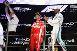 (L to R): Bradley Lord (GBR) Mercedes AMG F1 Communications Manager celebrates on the podium with Sebastian Vettel (GER) Ferrari and race winner Lewis Hamilton (GBR) Mercedes AMG F1. 25.11.2018. Formula 1 World Championship, Rd 21, Abu Dhabi Grand Prix, Yas Marina Circuit, Abu Dhabi, Race Day.