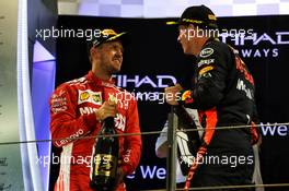 The podium (L to R): second placed Sebastian Vettel (GER) Ferrari celebrates with third placed Max Verstappen (NLD) Red Bull Racing. 25.11.2018. Formula 1 World Championship, Rd 21, Abu Dhabi Grand Prix, Yas Marina Circuit, Abu Dhabi, Race Day.