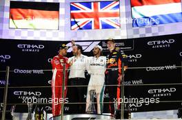 The podium (L to R): Sebastian Vettel (GER) Ferrari, second; Bradley Lord (GBR) Mercedes AMG F1 Communications Manager; Lewis Hamilton (GBR) Mercedes AMG F1, race winner; Max Verstappen (NLD) Red Bull Racing, third. 25.11.2018. Formula 1 World Championship, Rd 21, Abu Dhabi Grand Prix, Yas Marina Circuit, Abu Dhabi, Race Day.