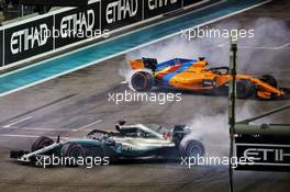 Race winner Lewis Hamilton (GBR) Mercedes AMG F1 W09 and Fernando Alonso (ESP) McLaren MCL33 perform doughnuts at the end of the race. 25.11.2018. Formula 1 World Championship, Rd 21, Abu Dhabi Grand Prix, Yas Marina Circuit, Abu Dhabi, Race Day.