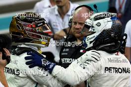(L to R): Lewis Hamilton (GBR) Mercedes AMG F1 celebrates his pole position in qualifying parc ferme with second placed team mate Valtteri Bottas (FIN) Mercedes AMG F1. 24.11.2018. Formula 1 World Championship, Rd 21, Abu Dhabi Grand Prix, Yas Marina Circuit, Abu Dhabi, Qualifying Day.