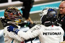 (L to R): Lewis Hamilton (GBR) Mercedes AMG F1 celebrates his pole position with team mate Valtteri Bottas (FIN) Mercedes AMG F1 in qualifying parc ferme. 24.11.2018. Formula 1 World Championship, Rd 21, Abu Dhabi Grand Prix, Yas Marina Circuit, Abu Dhabi, Qualifying Day.