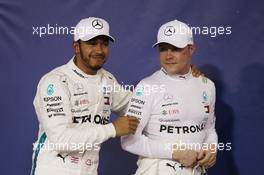 (L to R): Lewis Hamilton (GBR) Mercedes AMG F1 celebrates his pole position in qualifying parc ferme with second placed team mate Valtteri Bottas (FIN) Mercedes AMG F1. 24.11.2018. Formula 1 World Championship, Rd 21, Abu Dhabi Grand Prix, Yas Marina Circuit, Abu Dhabi, Qualifying Day.