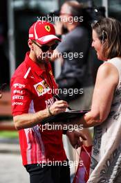 Sebastian Vettel (GER) Ferrari signs autographs for the fans. 25.11.2018. Formula 1 World Championship, Rd 21, Abu Dhabi Grand Prix, Yas Marina Circuit, Abu Dhabi, Race Day.