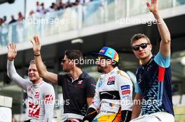 (L to R): Kevin Magnussen (DEN) Haas F1 Team; Romain Grosjean (FRA) Haas F1 Team; Fernando Alonso (ESP) McLaren; and Sergey Sirotkin (RUS) Williams, on the drivers parade. 25.11.2018. Formula 1 World Championship, Rd 21, Abu Dhabi Grand Prix, Yas Marina Circuit, Abu Dhabi, Race Day.