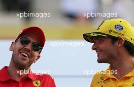 Sebastian Vettel (GER) Scuderia Ferrari and Carlos Sainz Jr (ESP) Renault F1 Team  25.11.2018. Formula 1 World Championship, Rd 21, Abu Dhabi Grand Prix, Yas Marina Circuit, Abu Dhabi, Race Day.