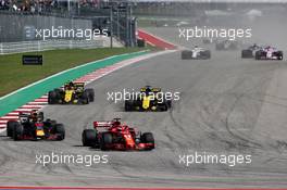 Sebastian Vettel (GER) Ferrari SF71H and Daniel Ricciardo (AUS) Red Bull Racing RB14 at the start of the race. 21.10.2018. Formula 1 World Championship, Rd 18, United States Grand Prix, Austin, Texas, USA, Race Day.