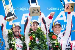(L to R): Race winners Fernando Alonso (ESP); Sebastien Buemi (SUI); and  Kazuki Nakajima (JPN) #08 Toyota Gazoo Racing, celebrate on the podium. 16-17.06.2018. FIA World Endurance Championship, Le Mans 24 Hours, Race, Le Mans, France.