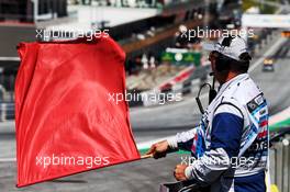 A marshal waves a red flag. 28.06.2019. Formula 1 World Championship, Rd 9, Austrian Grand Prix, Spielberg, Austria, Practice Day.
