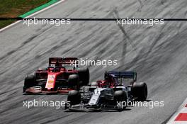 Kimi Raikkonen (FIN) Alfa Romeo Racing C38 and Sebastian Vettel (GER) Ferrari SF90 battle for position. 30.06.2019 Formula 1 World Championship, Rd 9, Austrian Grand Prix, Spielberg, Austria, Race Day.
