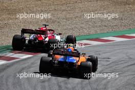 Lando Norris (GBR) McLaren MCL34 and Kimi Raikkonen (FIN) Alfa Romeo Racing C38. 30.06.2019 Formula 1 World Championship, Rd 9, Austrian Grand Prix, Spielberg, Austria, Race Day.
