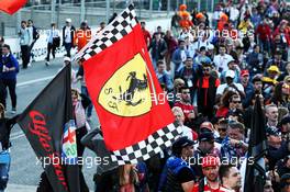 Ferrari and Alfa Romeo flag with fans at the podium. 28.04.2019. Formula 1 World Championship, Rd 4, Azerbaijan Grand Prix, Baku Street Circuit, Azerbaijan, Race Day.