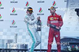 Race winner Valtteri Bottas (FIN) Mercedes AMG F1 celebrates on the podium with third placed Sebastian Vettel (GER) Ferrari. 28.04.2019. Formula 1 World Championship, Rd 4, Azerbaijan Grand Prix, Baku Street Circuit, Azerbaijan, Race Day.