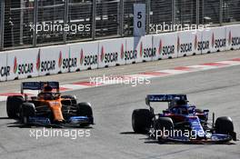 (L to R): Carlos Sainz Jr (ESP) McLaren MCL34 and Daniil Kvyat (RUS) Scuderia Toro Rosso STR14 battle for position. 28.04.2019. Formula 1 World Championship, Rd 4, Azerbaijan Grand Prix, Baku Street Circuit, Azerbaijan, Race Day.