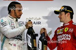 (L to R): Race winner Lewis Hamilton (GBR) Mercedes AMG F1 celebrates on the podium with third placed Charles Leclerc (MON) Ferrari. 31.03.2019. Formula 1 World Championship, Rd 2, Bahrain Grand Prix, Sakhir, Bahrain, Race Day.
