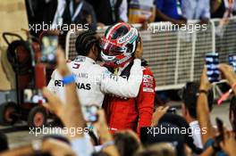 (L to R): Race winner Lewis Hamilton (GBR) Mercedes AMG F1 commiserates with third placed Charles Leclerc (MON) Ferrari in parc ferme. 31.03.2019. Formula 1 World Championship, Rd 2, Bahrain Grand Prix, Sakhir, Bahrain, Race Day.