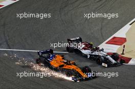 Carlos Sainz Jr (ESP) McLaren MCL34 sends sparks flying at the start of the race alongside Antonio Giovinazzi (ITA) Alfa Romeo Racing C38. 31.03.2019. Formula 1 World Championship, Rd 2, Bahrain Grand Prix, Sakhir, Bahrain, Race Day.