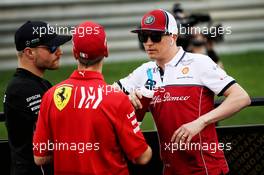 (L to R): Valtteri Bottas (FIN) Mercedes AMG F1 with Sebastian Vettel (GER) Ferrari and Kimi Raikkonen (FIN) Alfa Romeo Racing on the drivers parade. 31.03.2019. Formula 1 World Championship, Rd 2, Bahrain Grand Prix, Sakhir, Bahrain, Race Day.