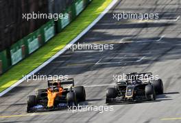 (L to R): Lando Norris (GBR) McLaren MCL34 and Romain Grosjean (FRA) Haas F1 Team VF-19 battle for position. 17.11.2019. Formula 1 World Championship, Rd 20, Brazilian Grand Prix, Sao Paulo, Brazil, Race Day.